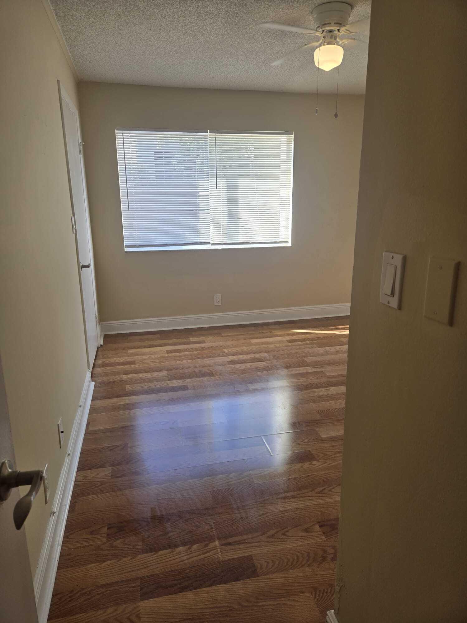 5780 Rock Island Road, Unit 367 Tamarac, FL 33319 - Photo 6 of 13 a view of wooden floor and window in a room