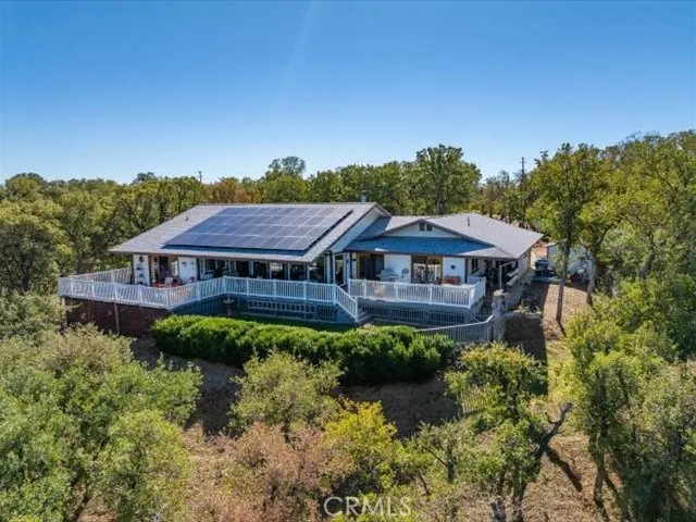 a view of a house with a yard and tree s