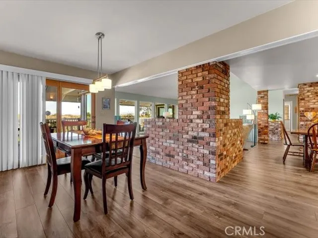 a kitchen with granite countertop white cabinets a sink and a window