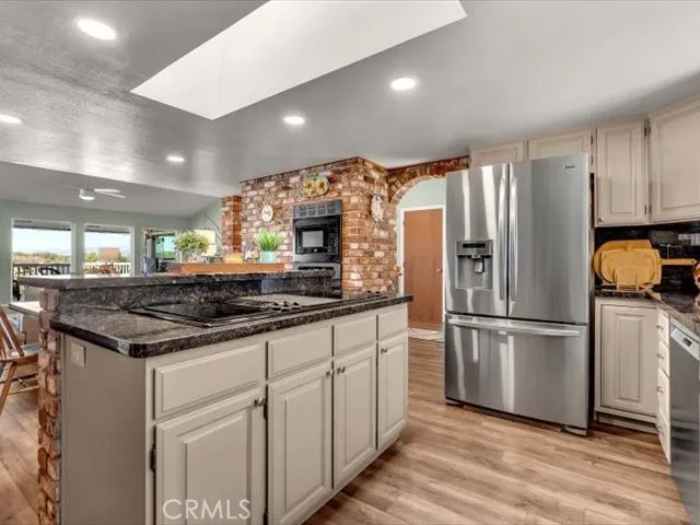 a bathroom with a sink a mirror and next to a window