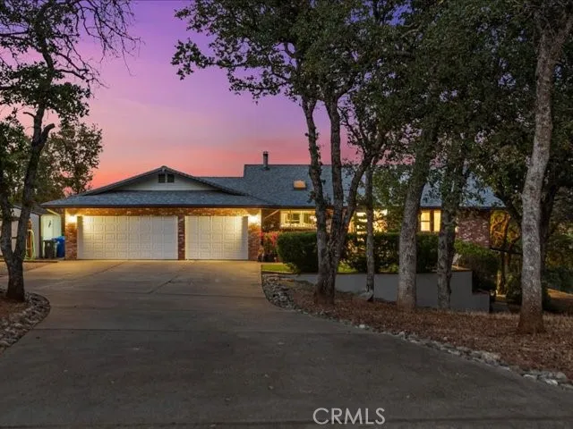 a view of a house with backyard and a patio