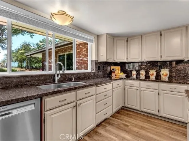 a spacious bedroom with a bed and a chandelier
