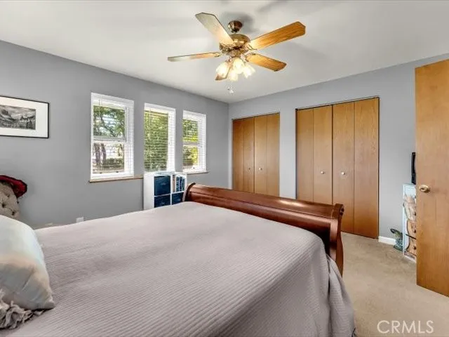 a living room with furniture a flat screen tv and a window