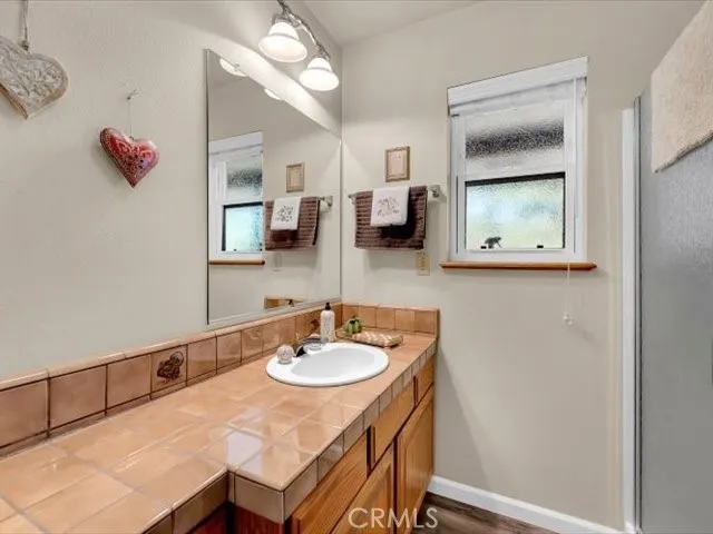 a view of a deck with two chair and wooden floor