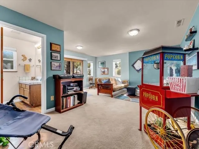 a balcony with wooden floor table and chairs