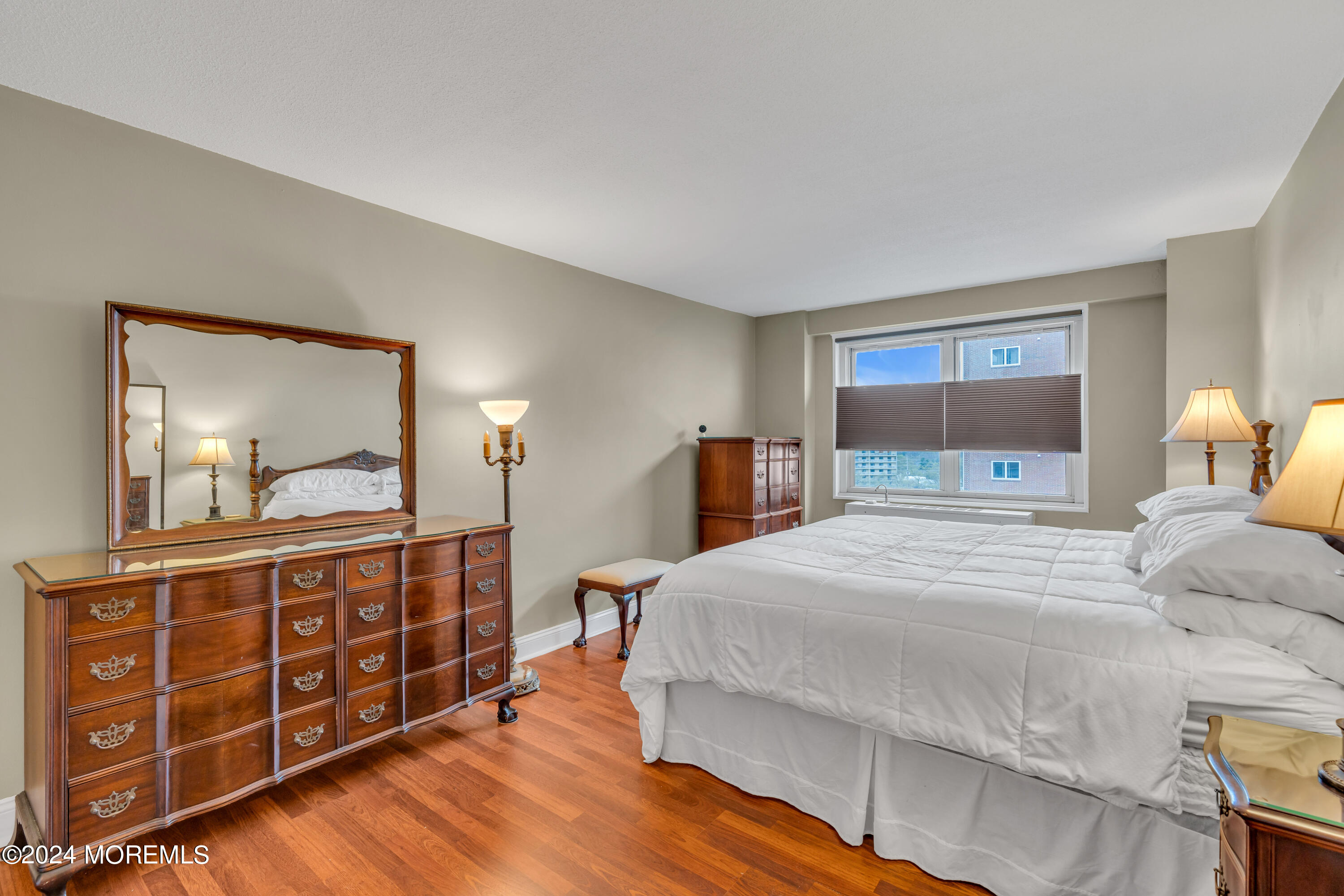 28 Riverside Avenue, Unit 7J Red Bank, NJ 07701 - Photo 13 of 25 a bedroom with a large bed and a dresser