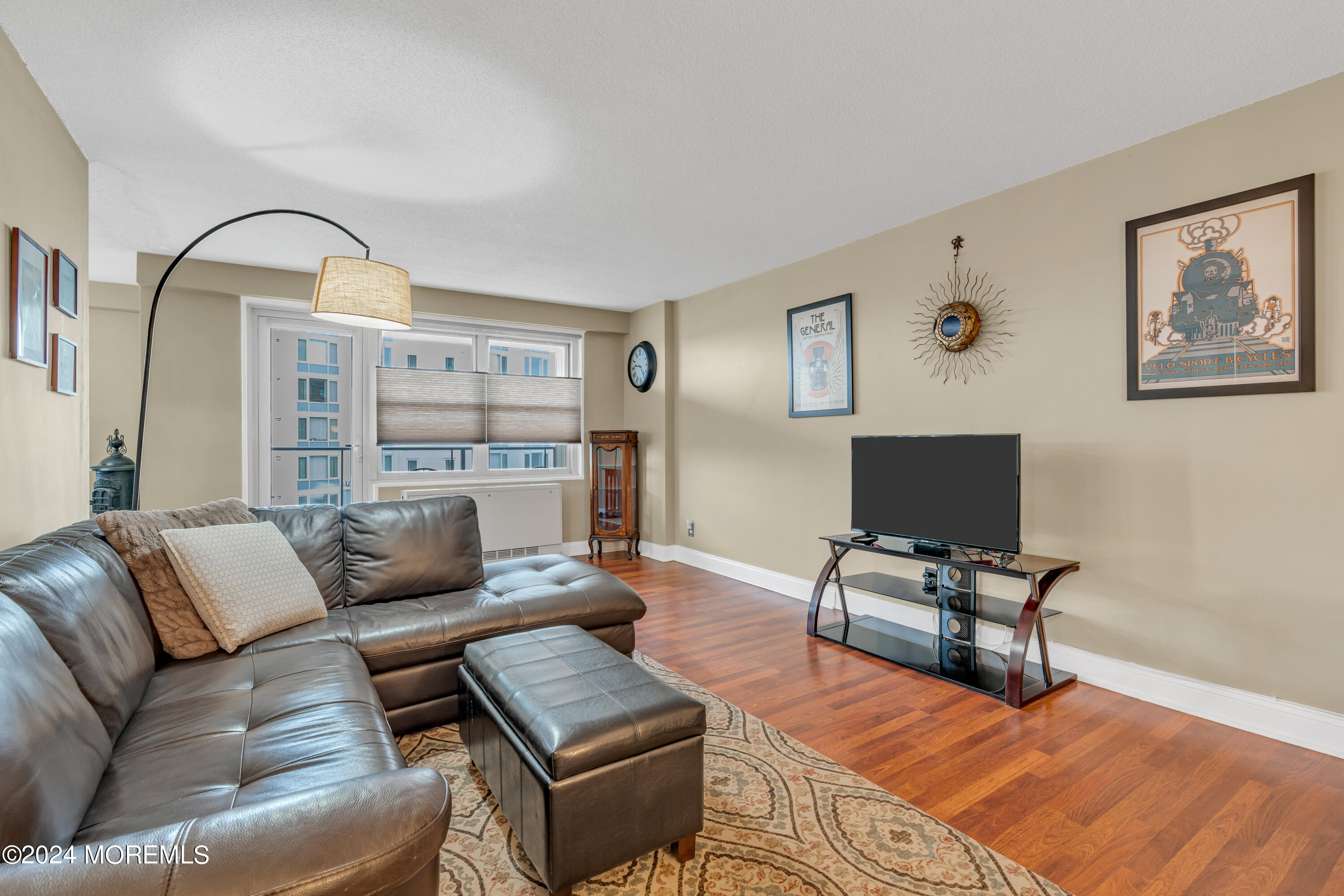 28 Riverside Avenue, Unit 7J Red Bank, NJ 07701 - Photo 3 of 25 a living room with furniture and a flat screen tv