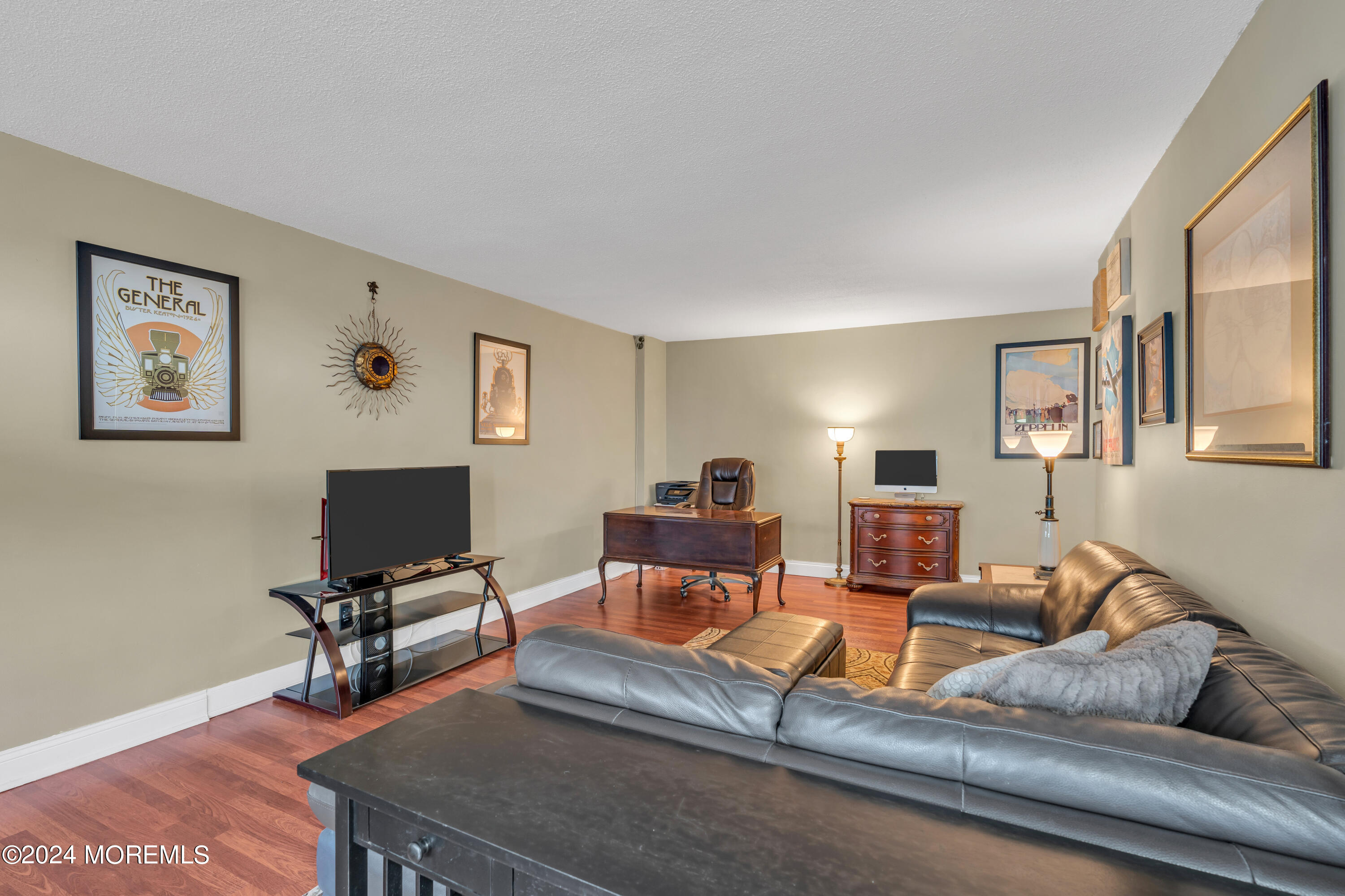 28 Riverside Avenue, Unit 7J Red Bank, NJ 07701 - Photo 4 of 25 a living room with furniture and a flat screen tv