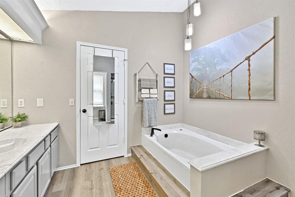 720 Bridget Way Hurst, TX 76054 - Photo 22 of 40 a bathroom with a tub sink and mirror