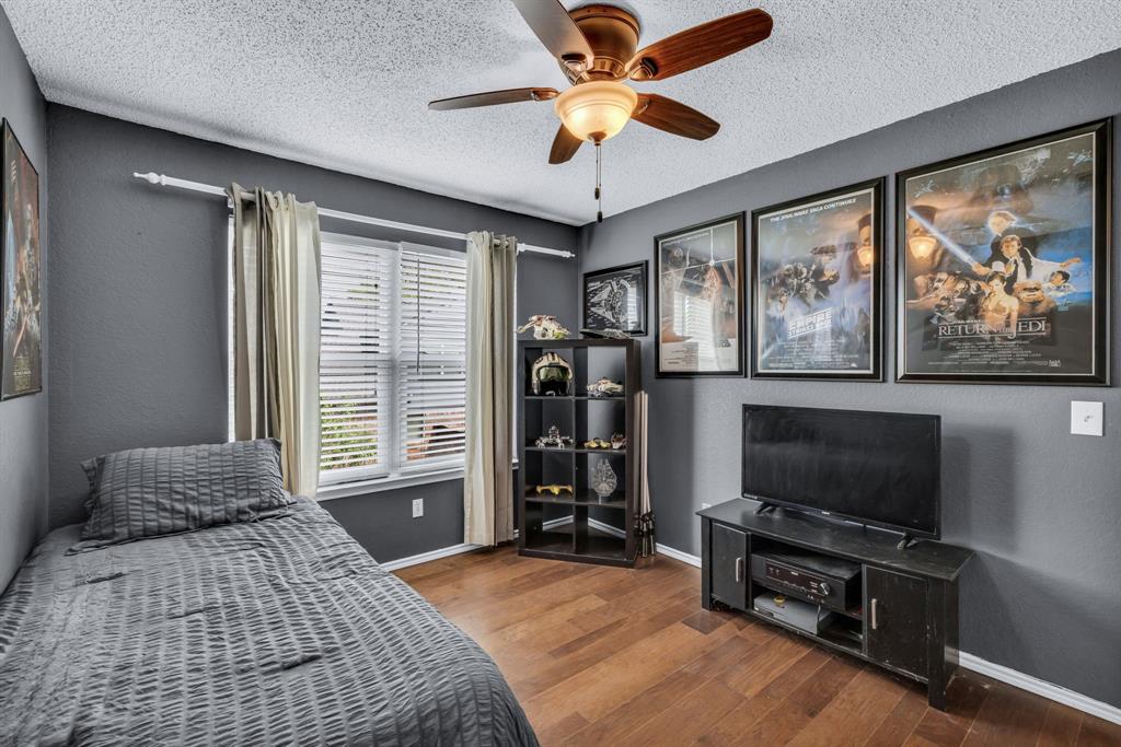 720 Bridget Way Hurst, TX 76054 - Photo 27 of 40 a bedroom with a bed and a flat screen tv
