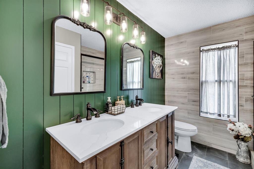 720 Bridget Way Hurst, TX 76054 - Photo 29 of 40 a bathroom with a double vanity sink and a mirror