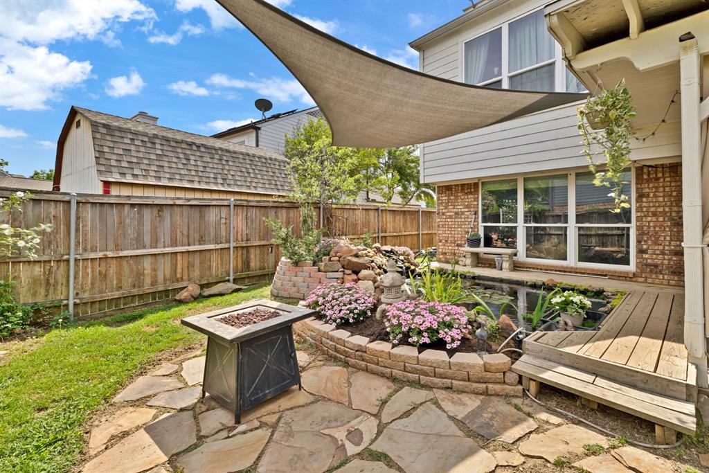 720 Bridget Way Hurst, TX 76054 - Photo 34 of 40 a view of a chairs and table in the back yard of the house
