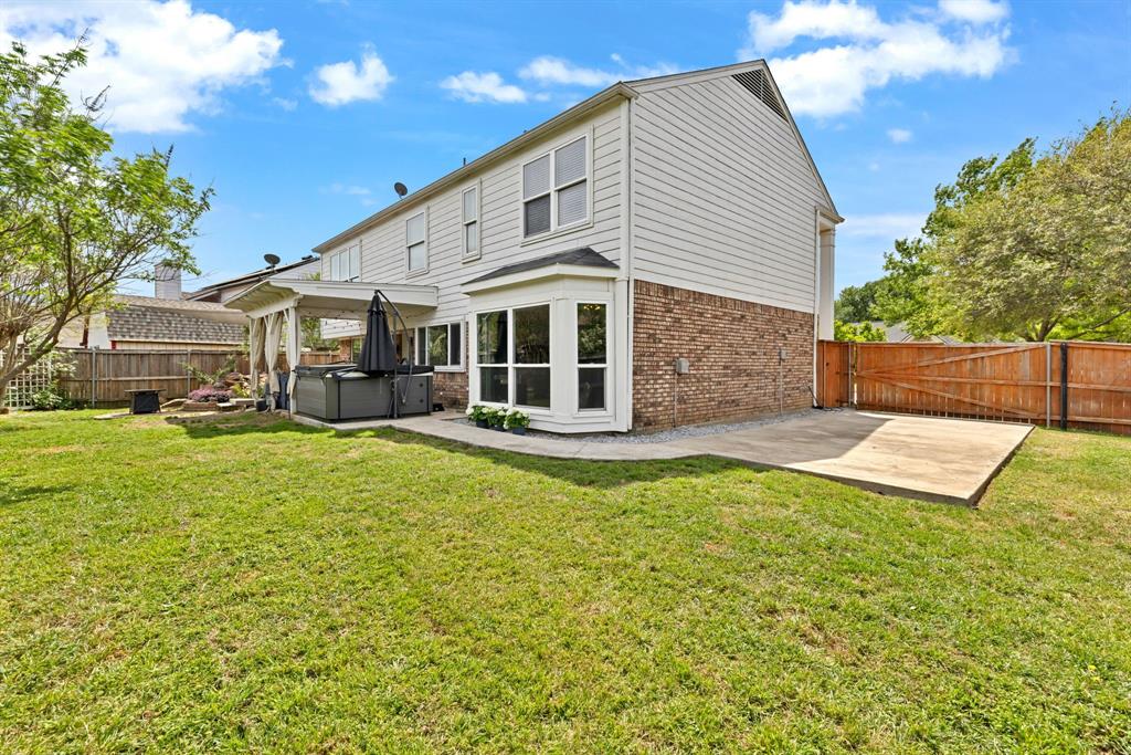 720 Bridget Way Hurst, TX 76054 - Photo 35 of 40 a view of a house with a backyard and a patio