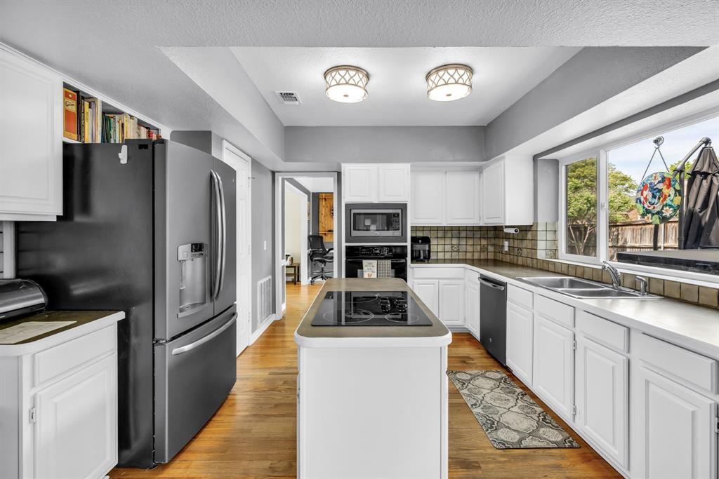 720 Bridget Way Hurst, TX 76054 - Photo 8 of 40 a kitchen with stainless steel appliances a stove top oven a refrigerator a sink and dishwasher