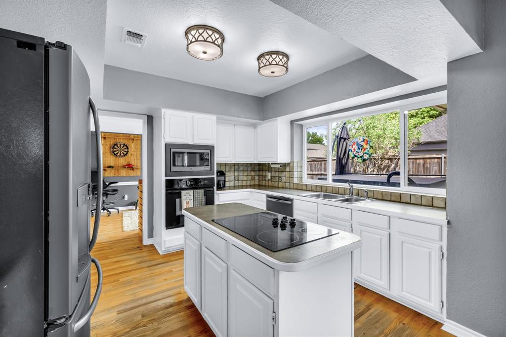 720 Bridget Way Hurst, TX 76054 - Photo 9 of 40 a kitchen with stainless steel appliances granite countertop a sink and a refrigerator