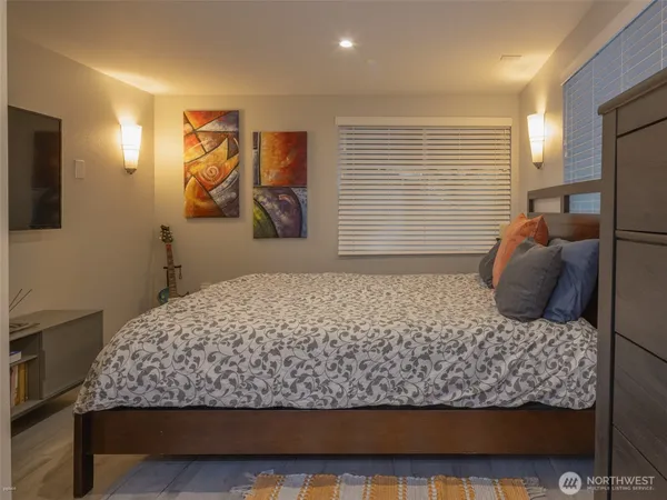 a bedroom with a large bed and a window