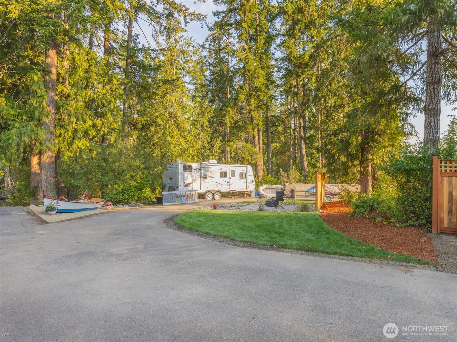 5440 East Grapeview Loop Road Allyn, WA 98524 - Photo 20 of 32 a view of a street with a building and trees in the background