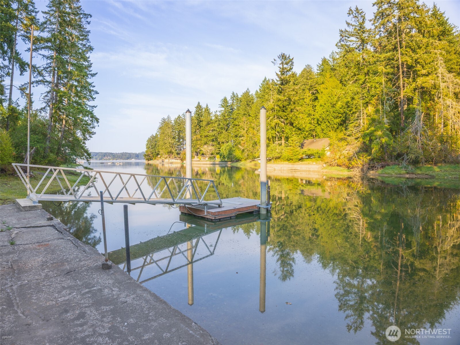 5440 East Grapeview Loop Road Allyn, WA 98524 - Photo 22 of 30 a view of swimming pool with a table and chairs