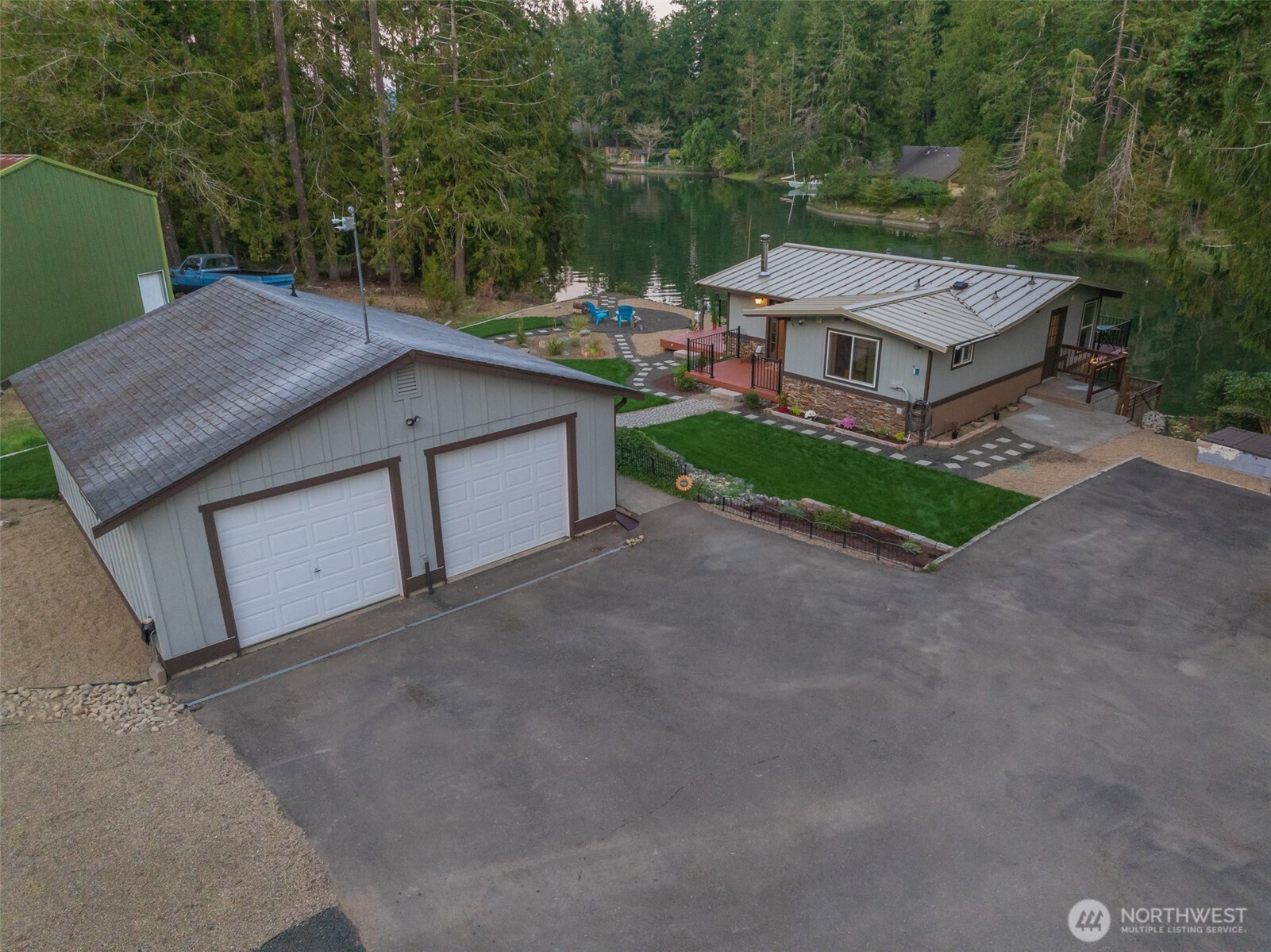 5440 East Grapeview Loop Road Allyn, WA 98524 - Photo 26 of 30 a view of a house with a yard and large tree