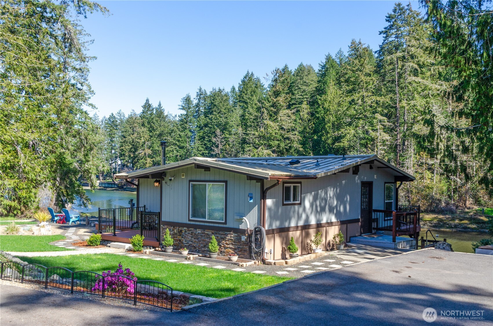 5440 East Grapeview Loop Road Allyn, WA 98524 - Photo 32 of 32 a view of a house with a yard patio and fire pit