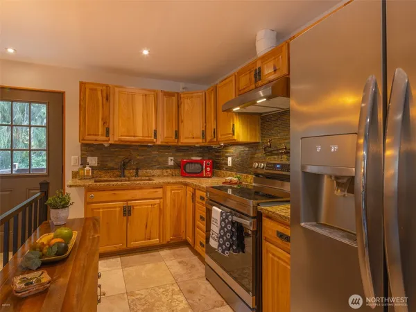 a kitchen with a sink cabinets and appliances