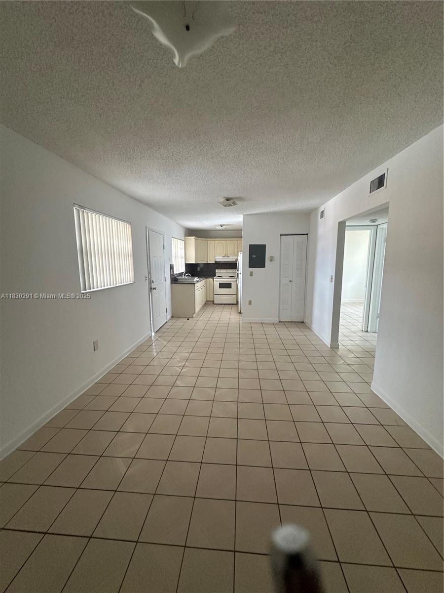 120 West 9th Street, Unit 102 Hialeah, FL 33010 - Photo 1 of 5 a room with a bed and a window