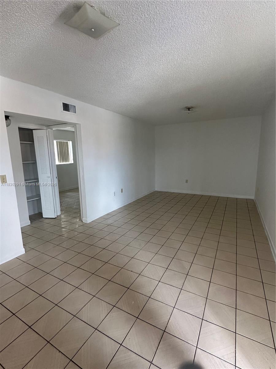 120 West 9th Street, Unit 102 Hialeah, FL 33010 - Photo 2 of 5 an empty room with white walls