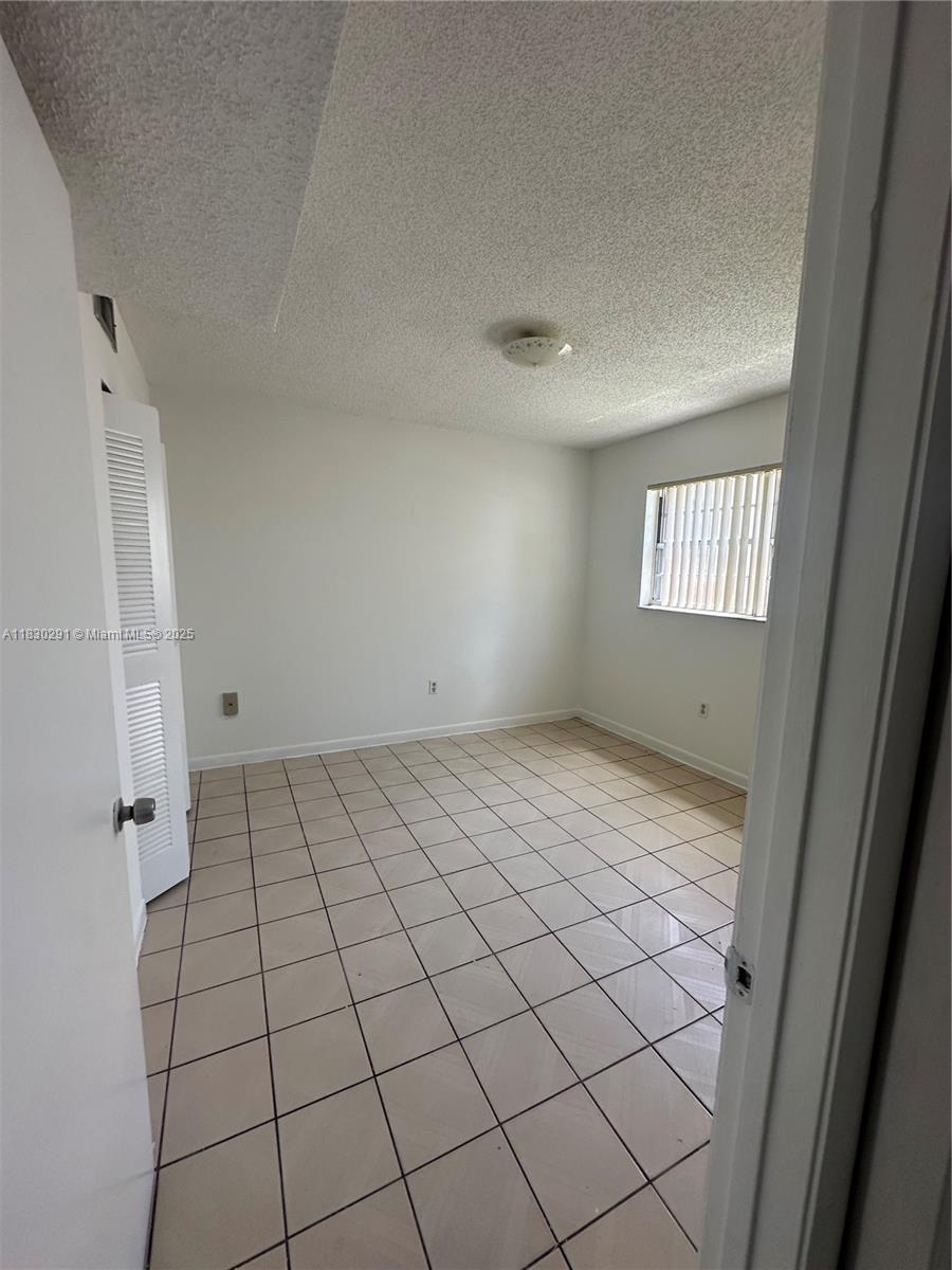 120 West 9th Street, Unit 102 Hialeah, FL 33010 - Photo 5 of 5 a view of an empty room and window