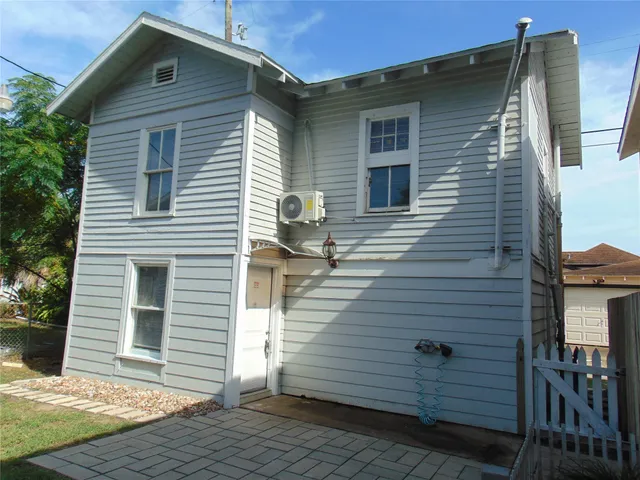a front view of a house with wooden fence
