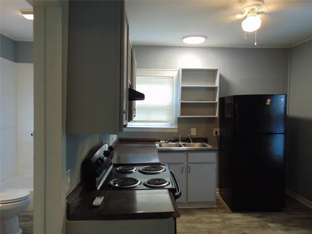 a kitchen with a refrigerator stove and a sink
