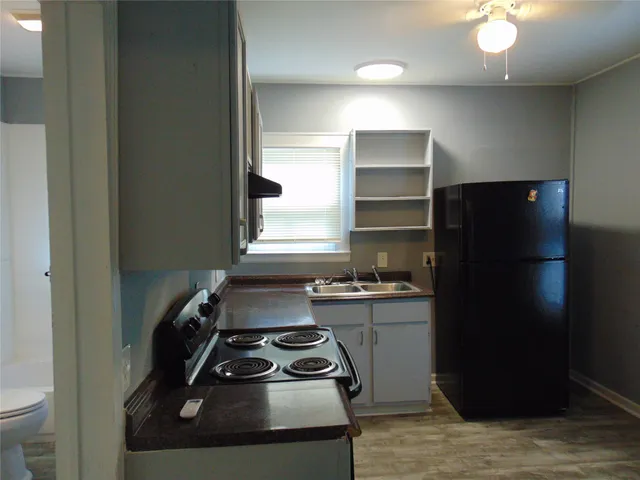 a kitchen with a sink stove and refrigerator