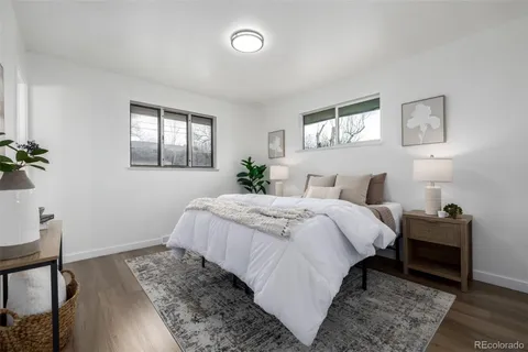 a bedroom with bed and wooden floor