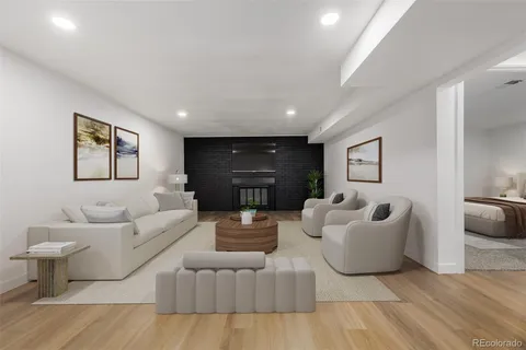 a living room with furniture and a wooden floor