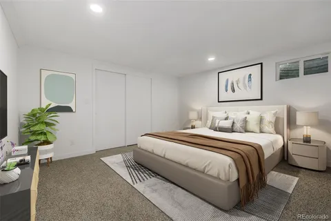 a bedroom with a bed and a potted plant