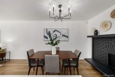 a dining room with furniture and wooden floor