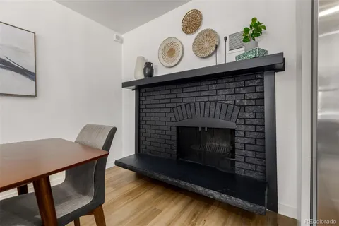 a living room with a table chairs and a fireplace