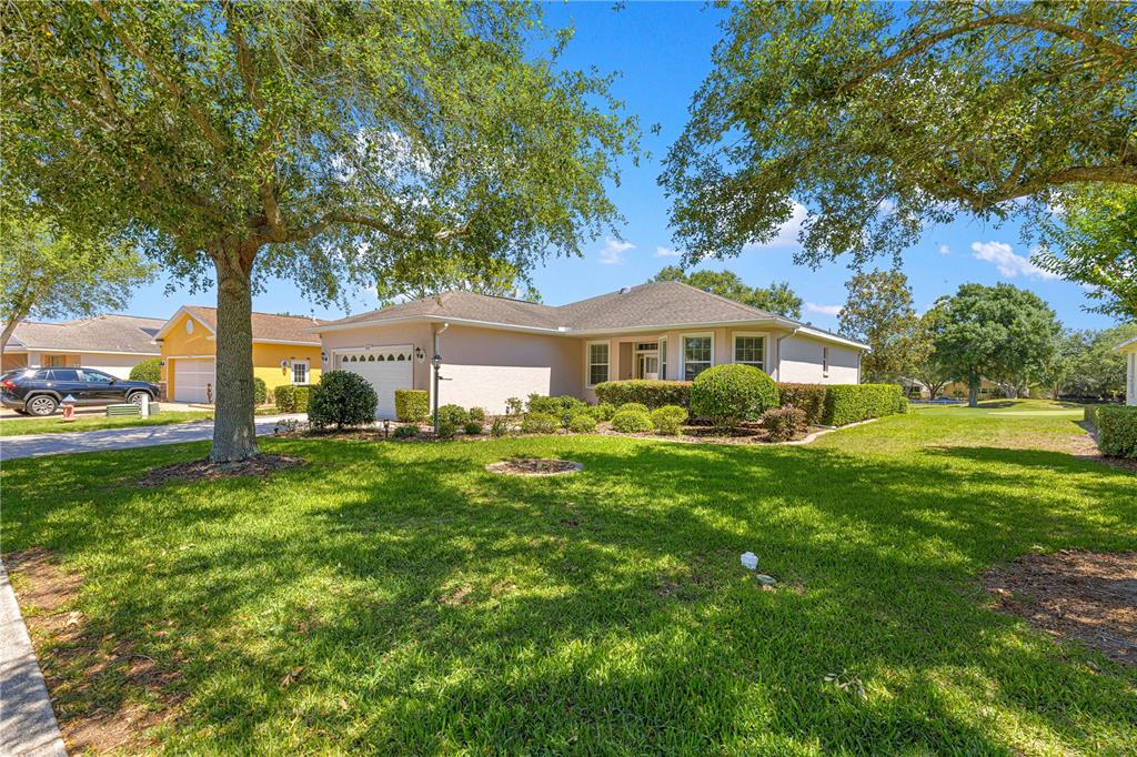9317 Southwest 94th Loop Ocala, FL 34481 - Photo 40 of 40 a front view of a house with a yard