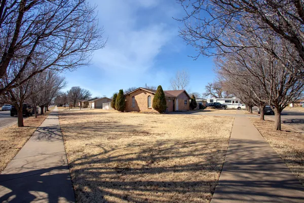 a view of a yard covered with snow in front of house