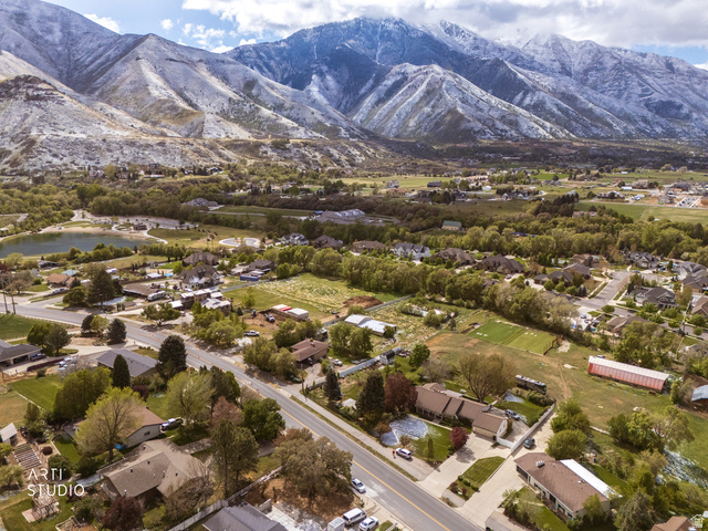 2672 East Canyon Road Springville, UT 84663 - Photo 18 of 33 Aerial view of residential area featuring a mountainous background