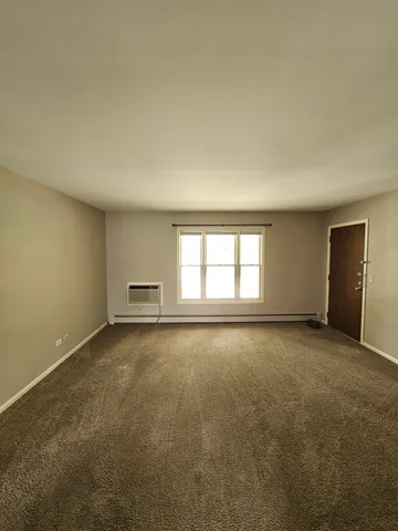 an empty room with a empty space and windows