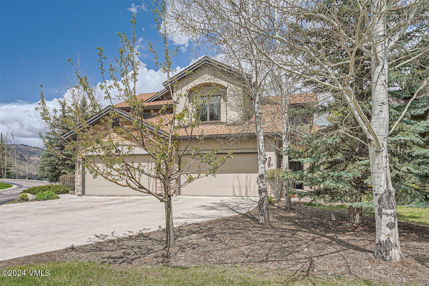 a house that has a tree in front of the house