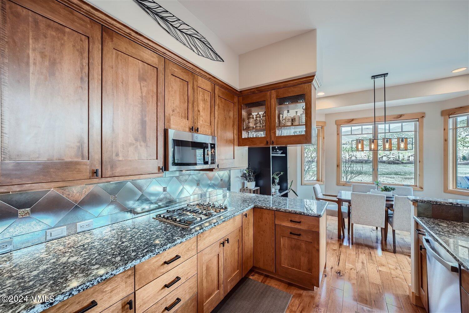104 North Brett Edwards, CO 81632 - Photo 12 of 32 a kitchen with stainless steel appliances granite countertop a stove a sink and a microwave