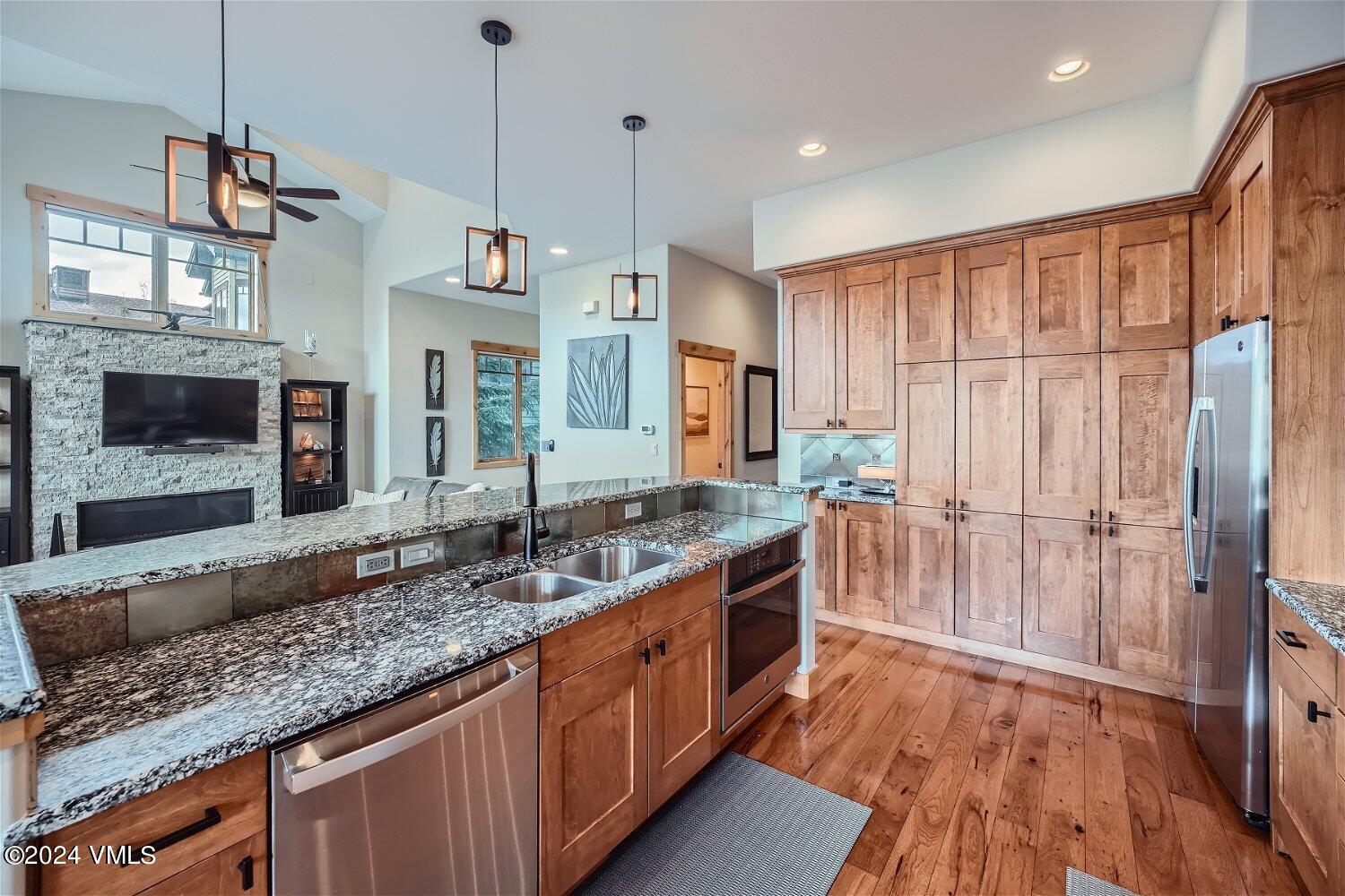 104 North Brett Edwards, CO 81632 - Photo 13 of 32 a kitchen with stainless steel appliances granite countertop a sink stove and refrigerator