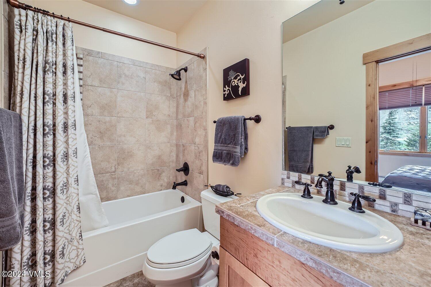 104 North Brett Edwards, CO 81632 - Photo 20 of 32 a bathroom with a granite countertop sink toilet and shower
