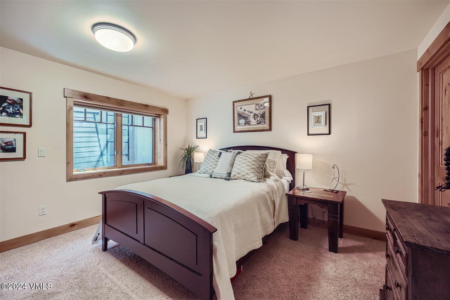104 North Brett Edwards, CO 81632 - Photo 23 of 32 a bed sitting in a bedroom next to a window