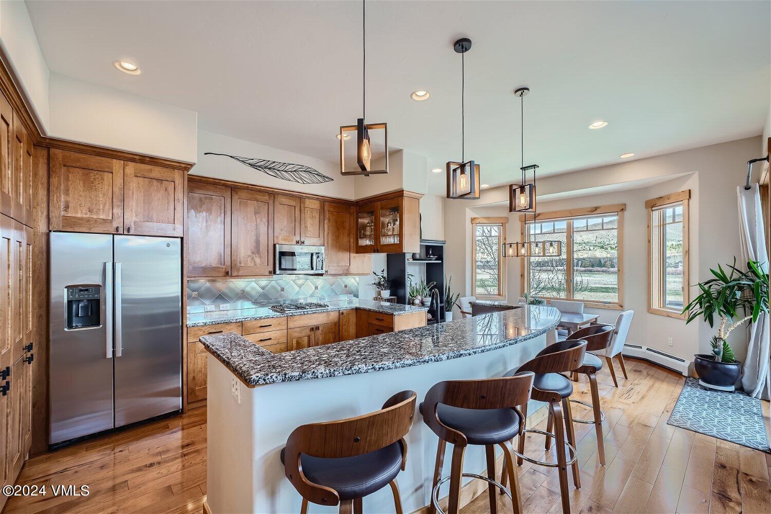 104 North Brett Edwards, CO 81632 - Photo 10 of 32 a kitchen with granite countertop kitchen island stainless steel appliances a table and chairs