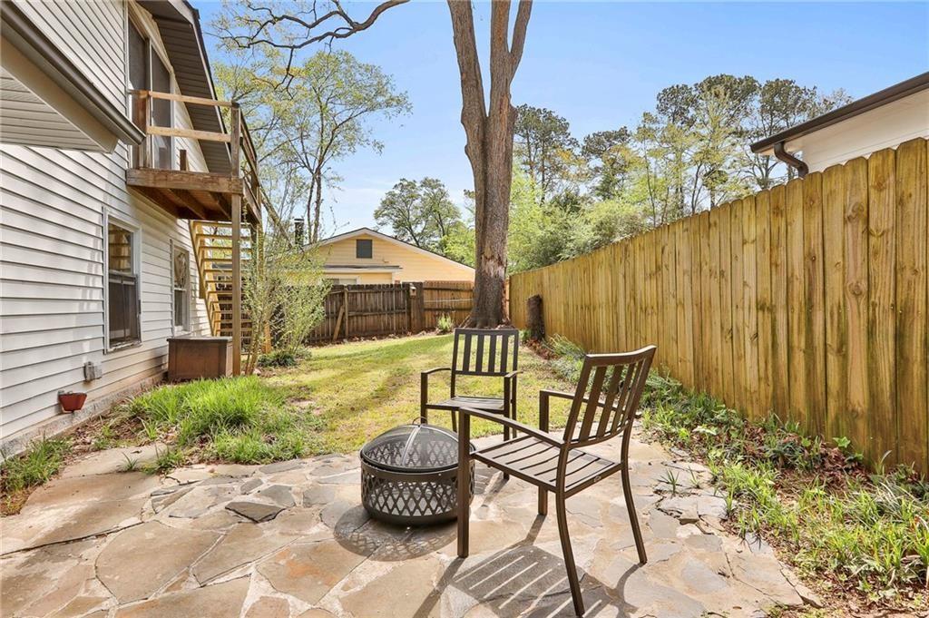 2037 A Lively Ridge Road Northeast Atlanta, GA 30329 - Photo 10 of 15 a patio with table and chairs and potted plants