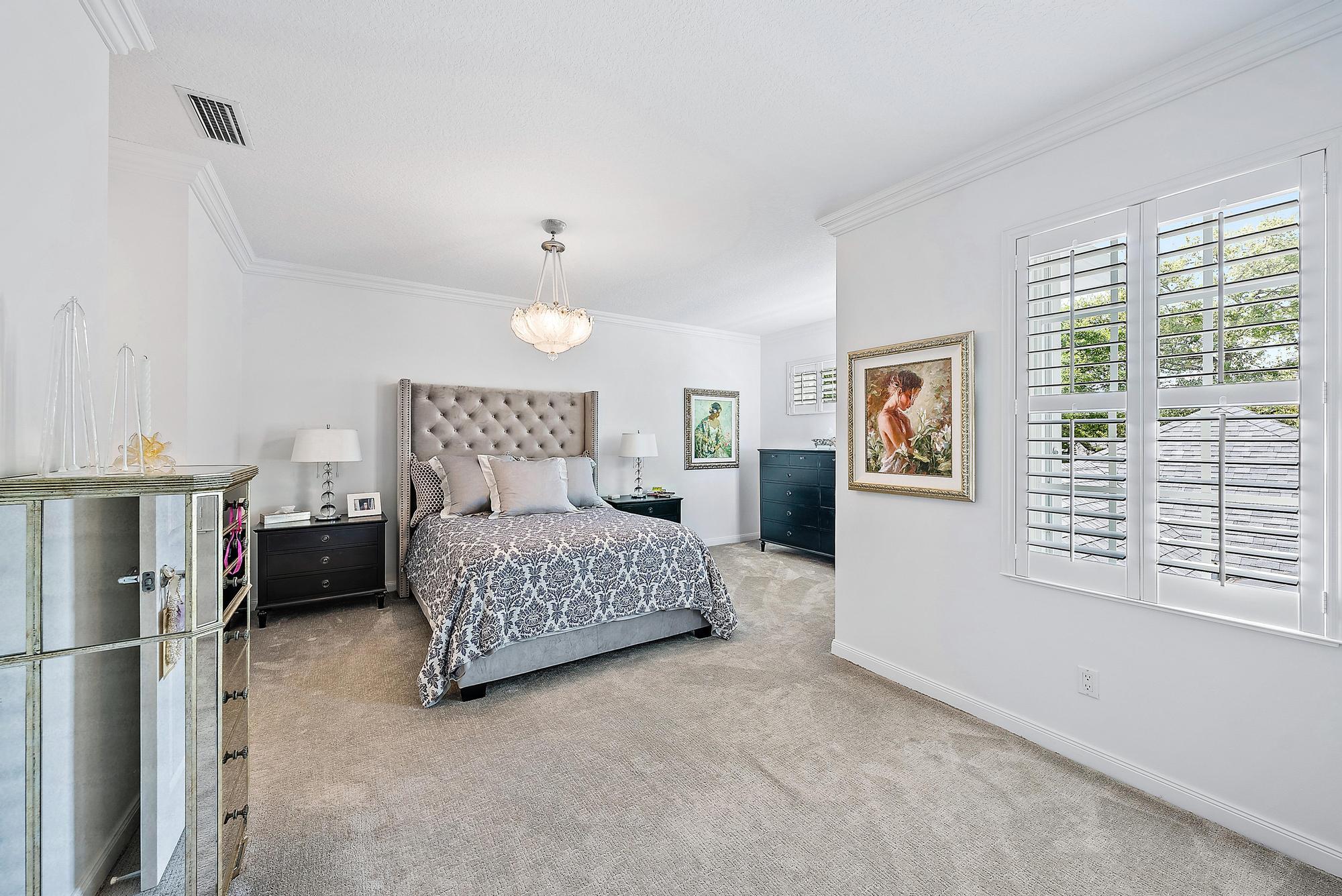 312 Bougainvillea Drive Jupiter, FL 33458 - Photo 18 of 44 a bedroom with a bed dresser and a window