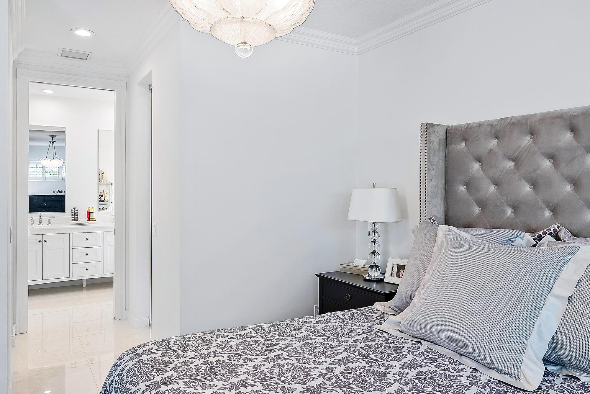 312 Bougainvillea Drive Jupiter, FL 33458 - Photo 19 of 44 a bedroom with a bed and a view of bathroom