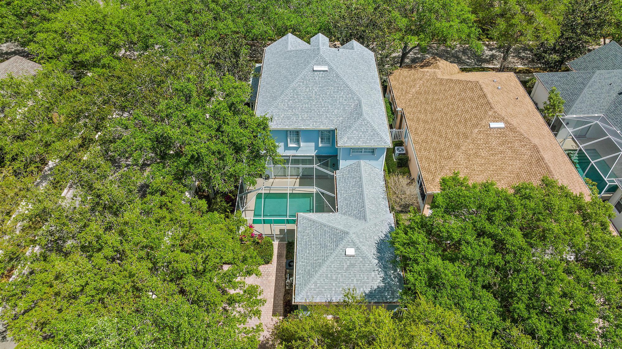 312 Bougainvillea Drive Jupiter, FL 33458 - Photo 33 of 44 an aerial view of a house with a yard and trees all around